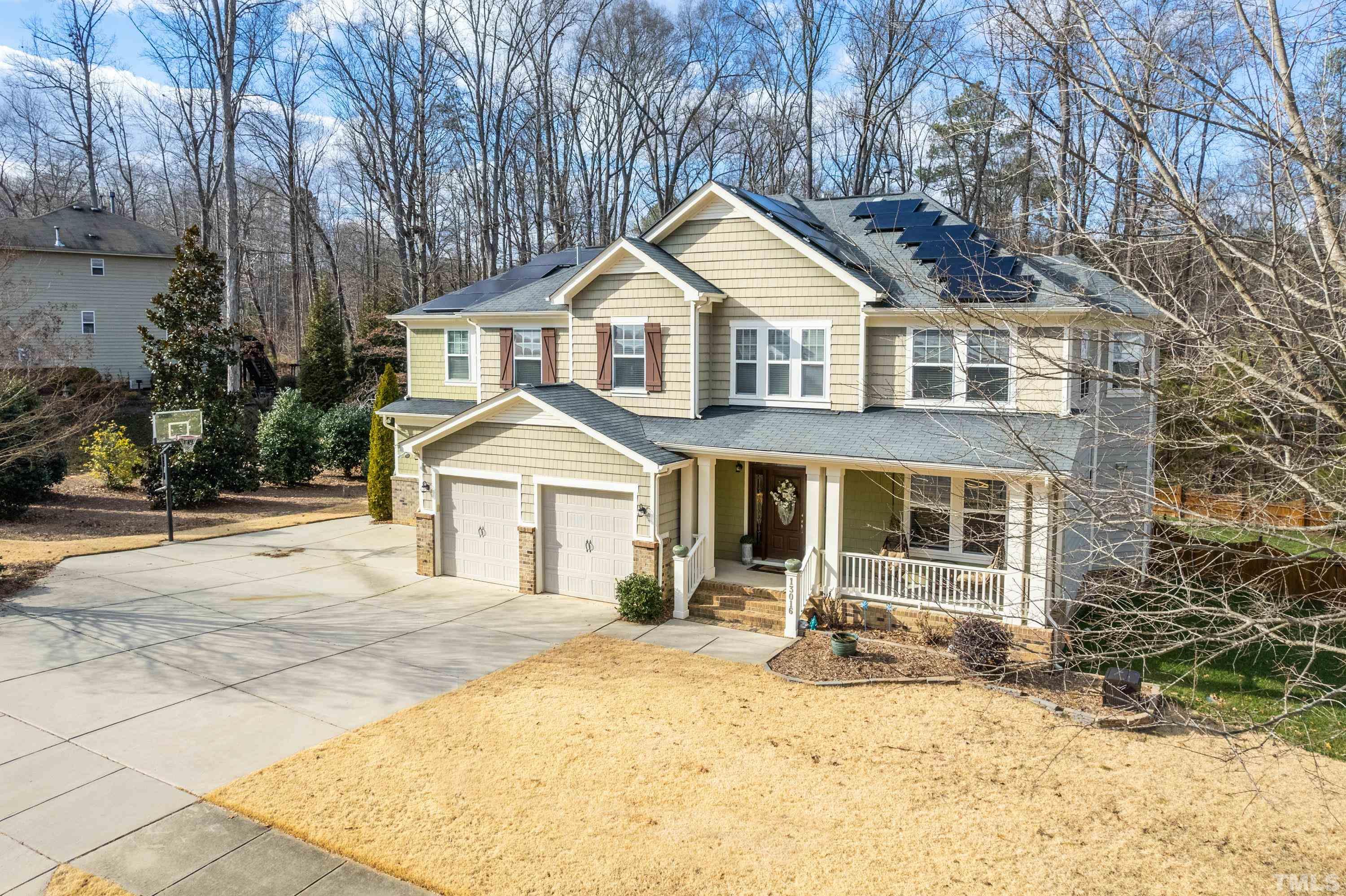 13016 Saxon Way Raleigh, NC 27613 - Photo 3 of 49 a front view of a house with a yard