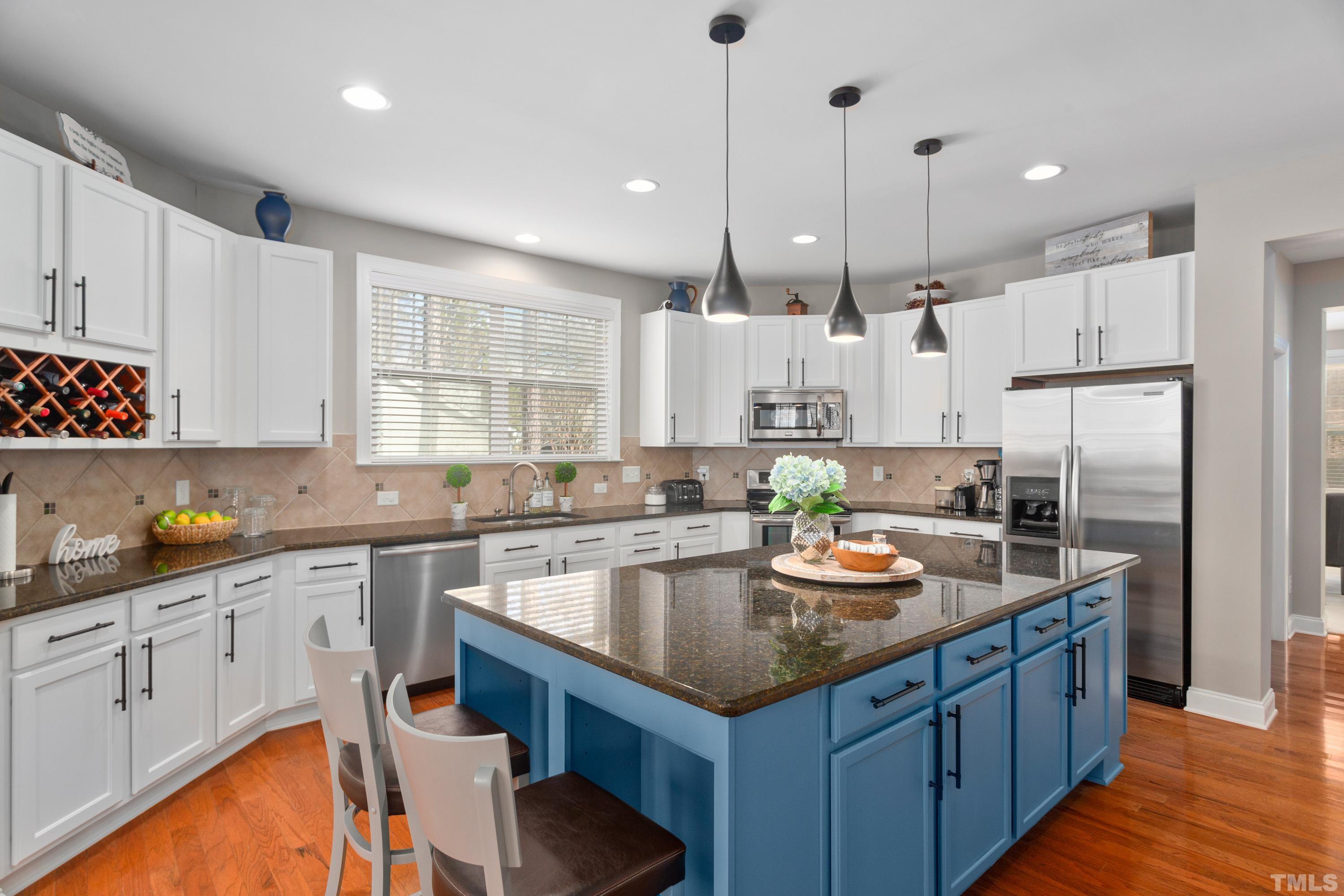 13016 Saxon Way Raleigh, NC 27613 - Photo 43 of 49 a kitchen with stainless steel appliances granite countertop a sink refrigerator and cabinets