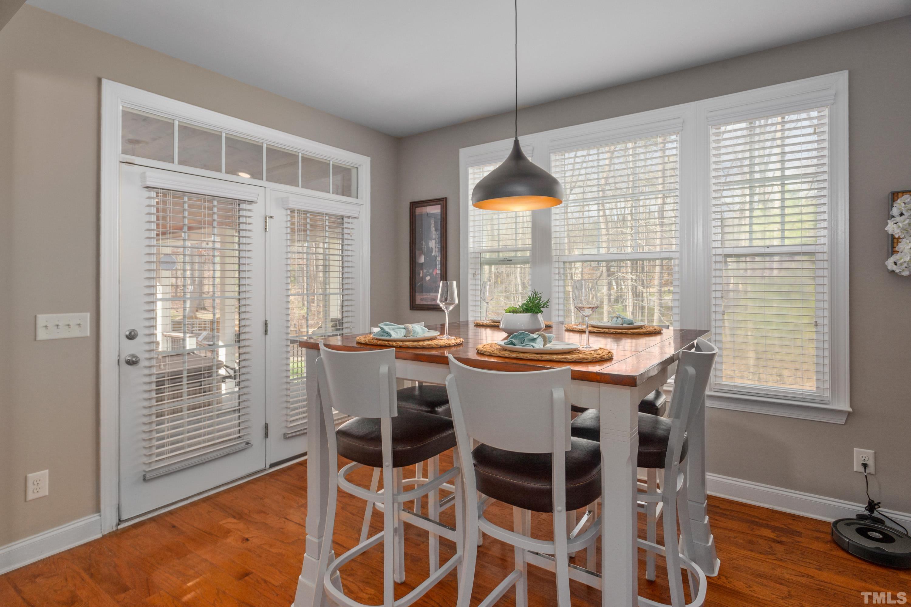 13016 Saxon Way Raleigh, NC 27613 - Photo 46 of 49 a dining room with furniture a chandelier and wooden floor