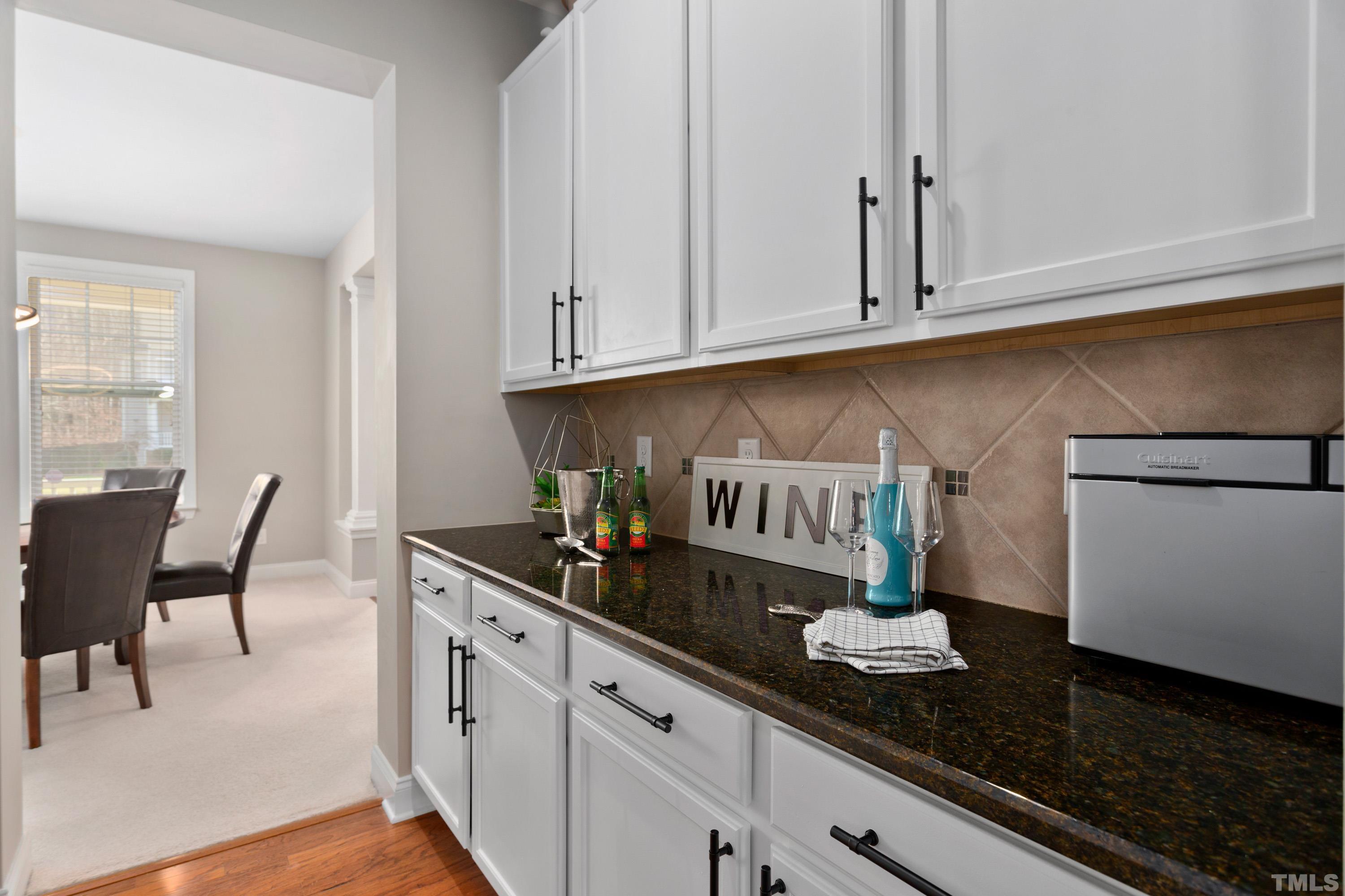 13016 Saxon Way Raleigh, NC 27613 - Photo 47 of 49 a kitchen with a table chairs and cabinets