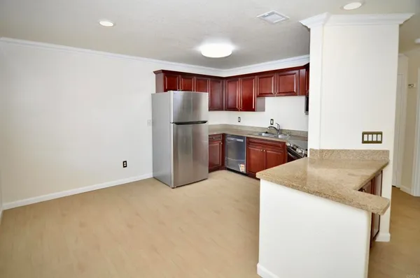a kitchen with stainless steel appliances granite countertop a sink stove and refrigerator
