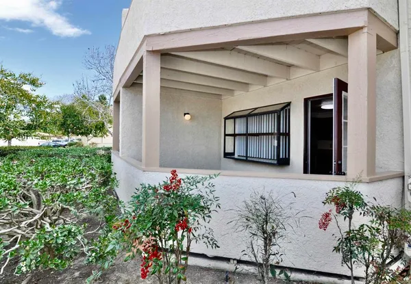 front view of a house with a flower garden