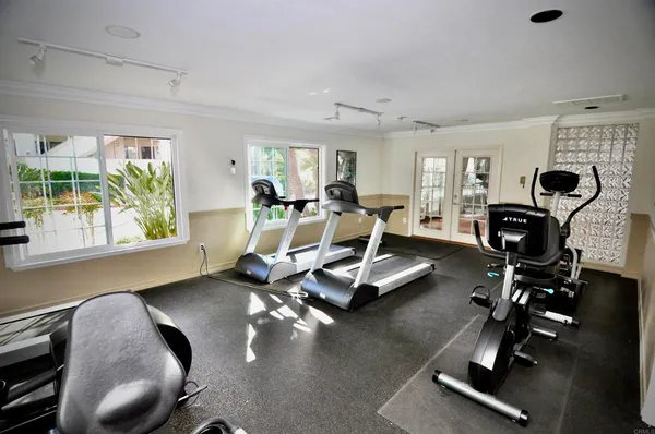 a room with gym equipment and a large window