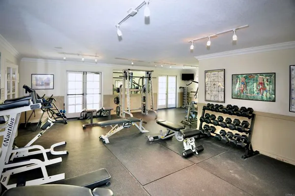 a room with gym equipment and a large window