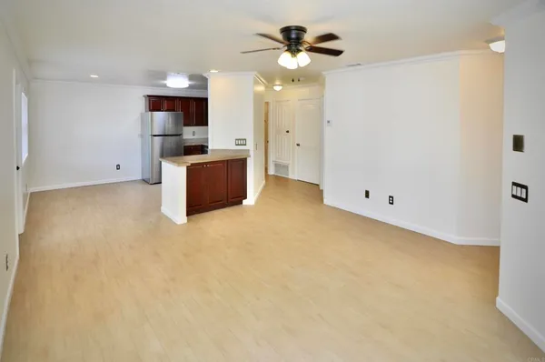 a view of a kitchen with a sink and a refrigerator