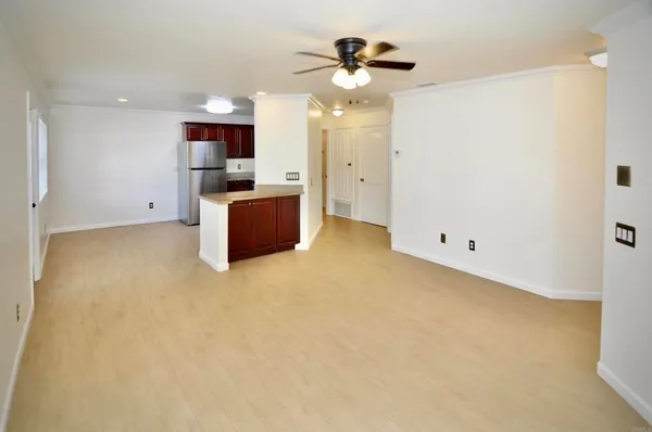 a view of a kitchen with a sink and a refrigerator