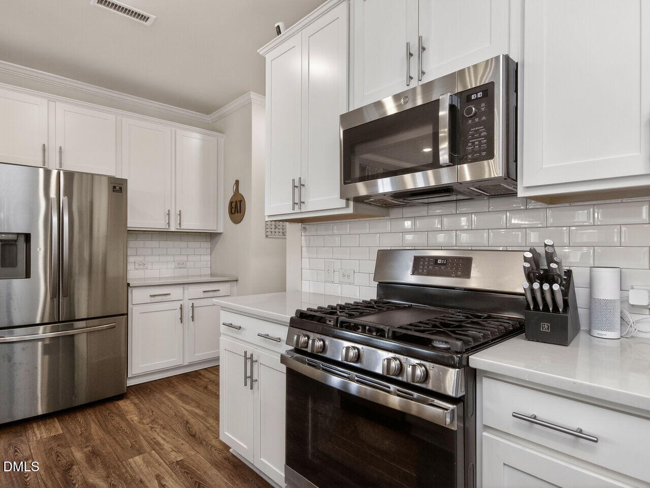 111 Velten Ridge Drive Durham, NC 27713 - Photo 11 of 32 a kitchen with stainless steel appliances granite countertop a stove a refrigerator and a microwave