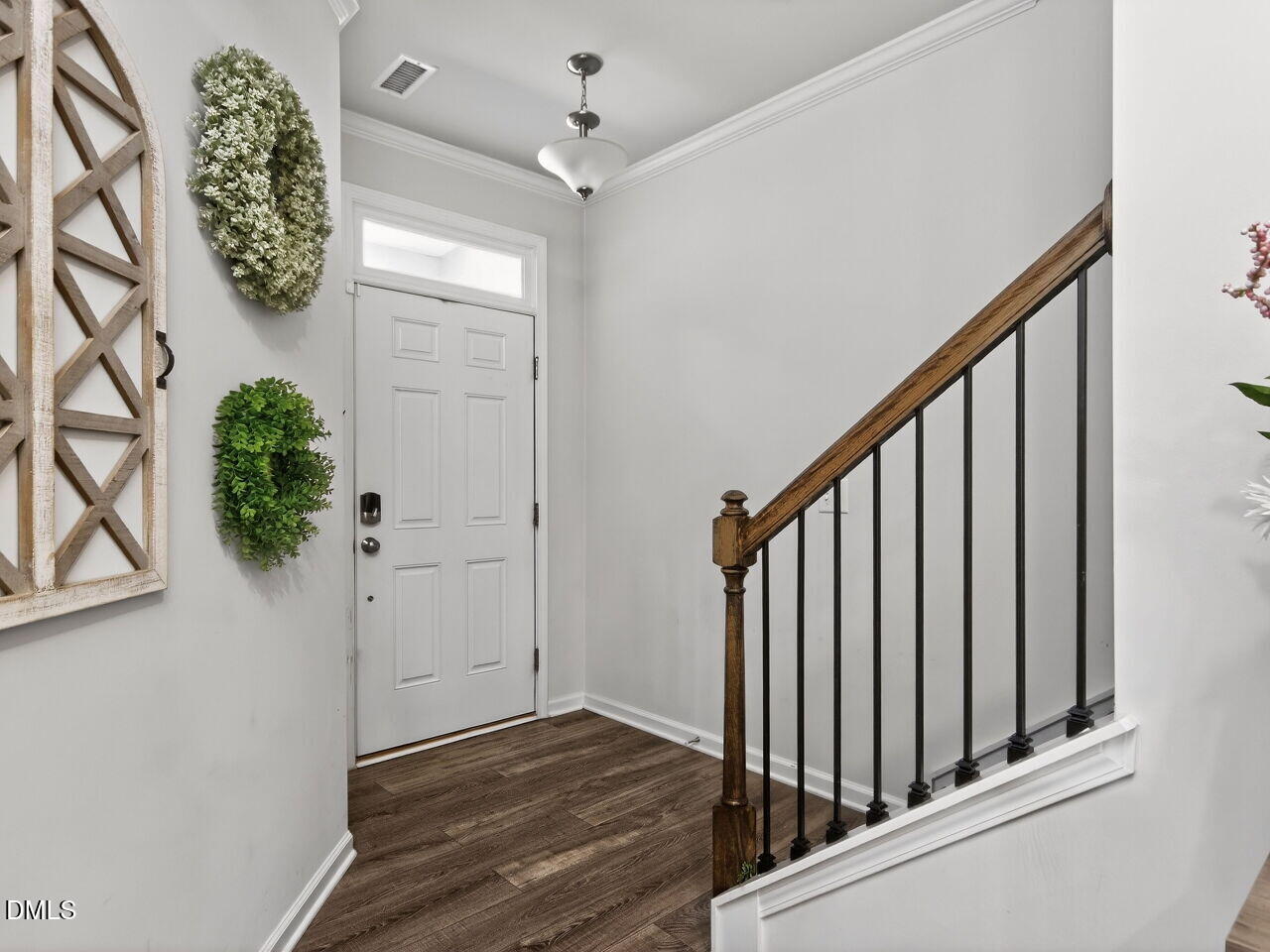 111 Velten Ridge Drive Durham, NC 27713 - Photo 4 of 32 a view of a hallway with wooden floor and stairs