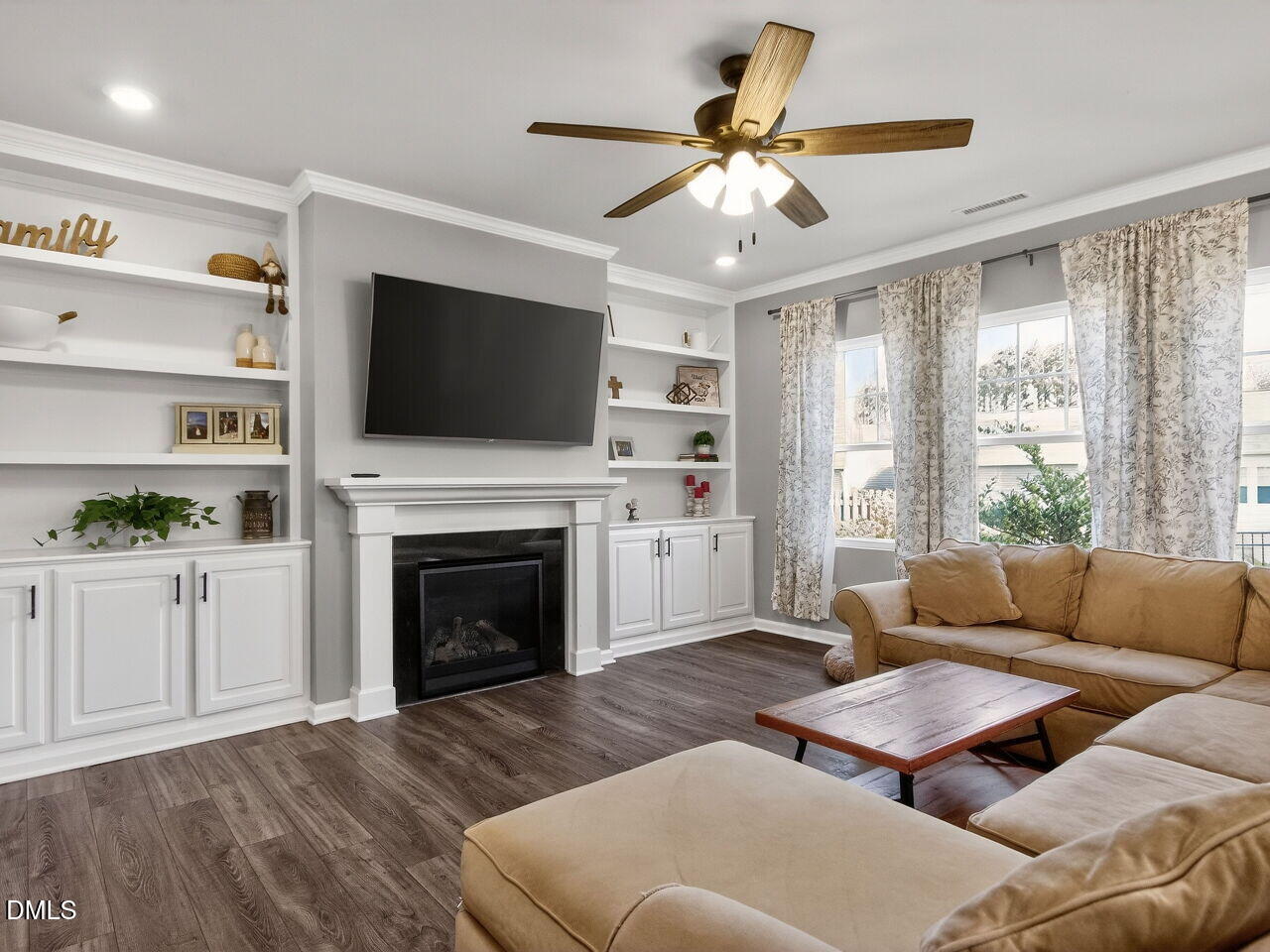111 Velten Ridge Drive Durham, NC 27713 - Photo 9 of 32 a living room with furniture a flat screen tv and a fireplace