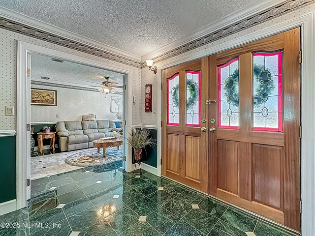 a living room with fireplace furniture and a large window