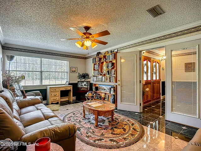 a bedroom with bed and a chandelier