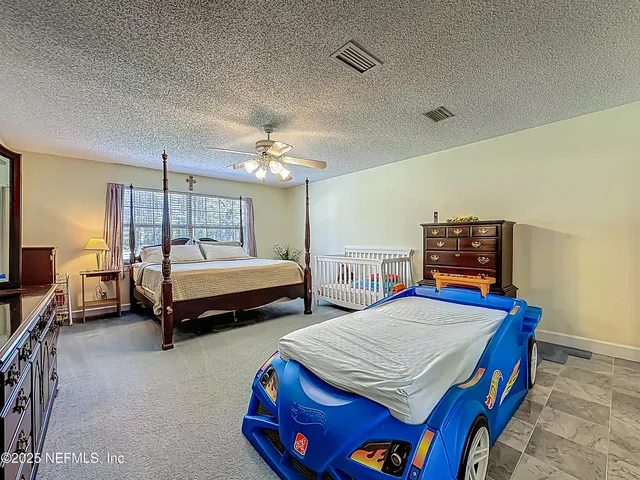 a bedroom with bed and a window