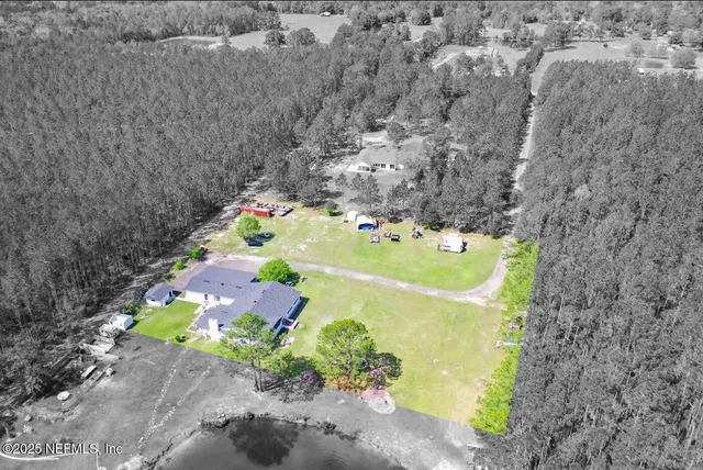 an aerial view of a house with a yard