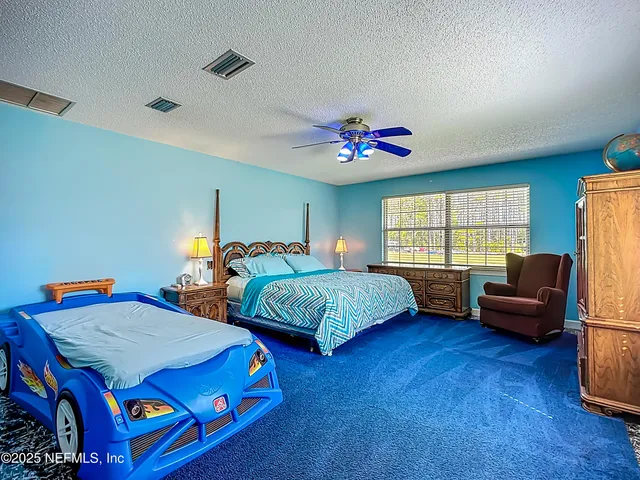 a bed sitting in a bedroom next to a window