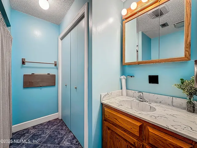 a view of a dining room with furniture and a chandelier