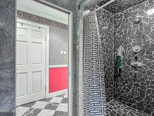 a living room with patio furniture and a flat screen tv