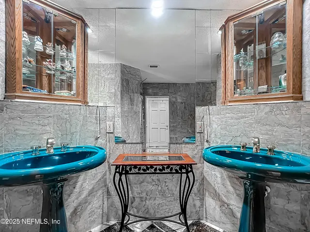 a dining room with a large window table and chairs