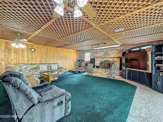 a kitchen with stainless steel appliances granite countertop a stove top oven a refrigerator a sink a dining table and chairs with wooden floor