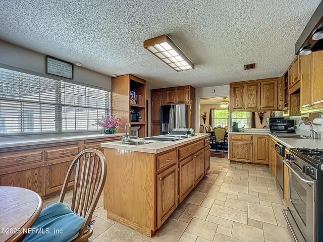 a view of a chair and tables in the back yard of the house
