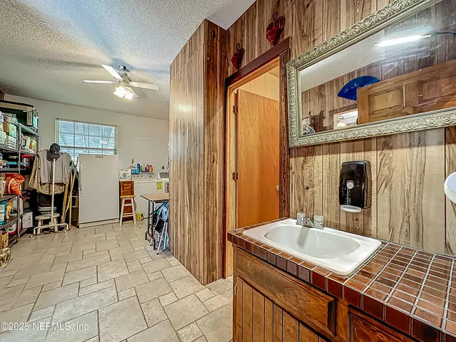 a view of a house with a yard and tree
