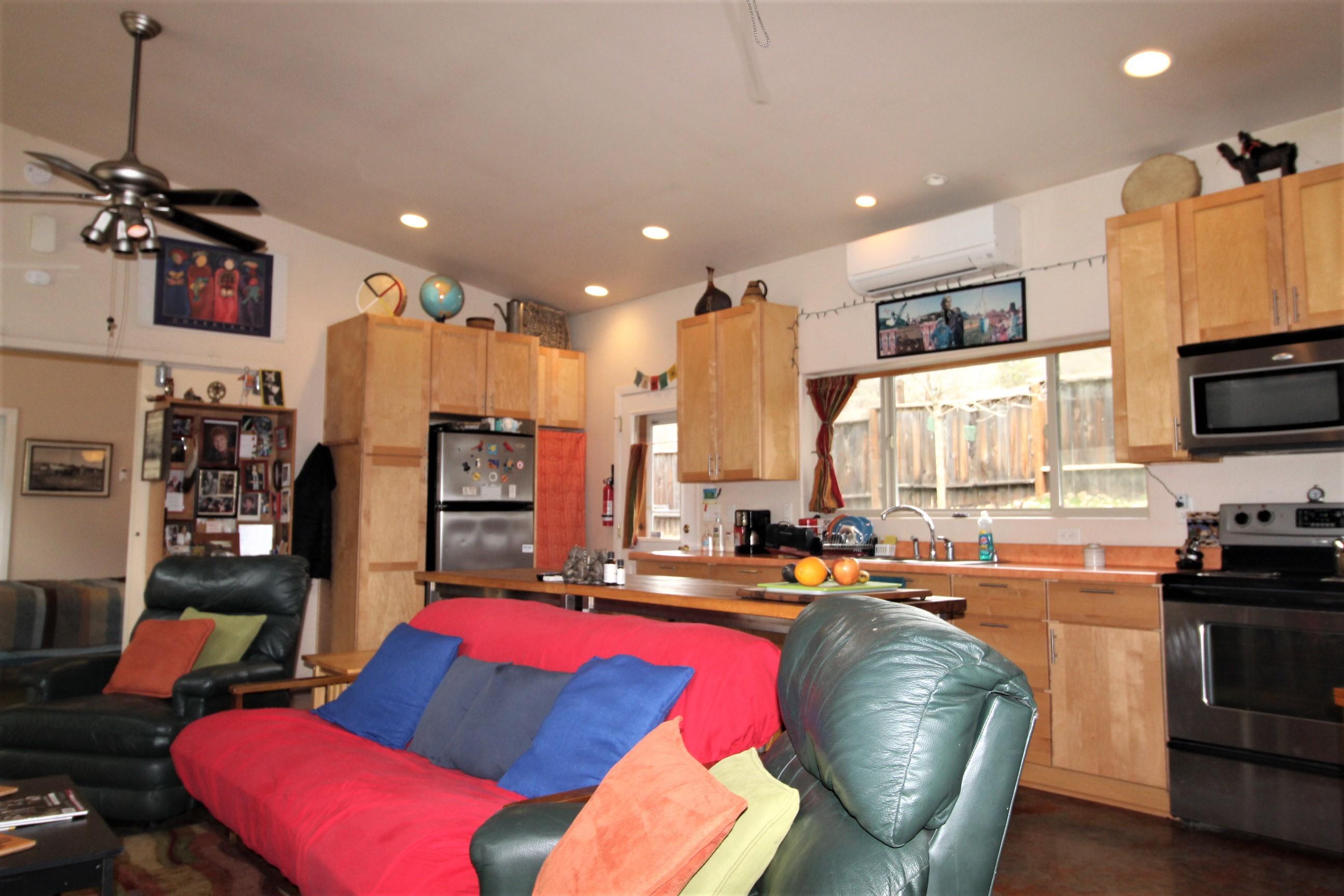 2200 Little Applegate Road Jacksonville, OR 97530 - Photo 5 of 39 a living room with furniture a flat screen tv and kitchen view
