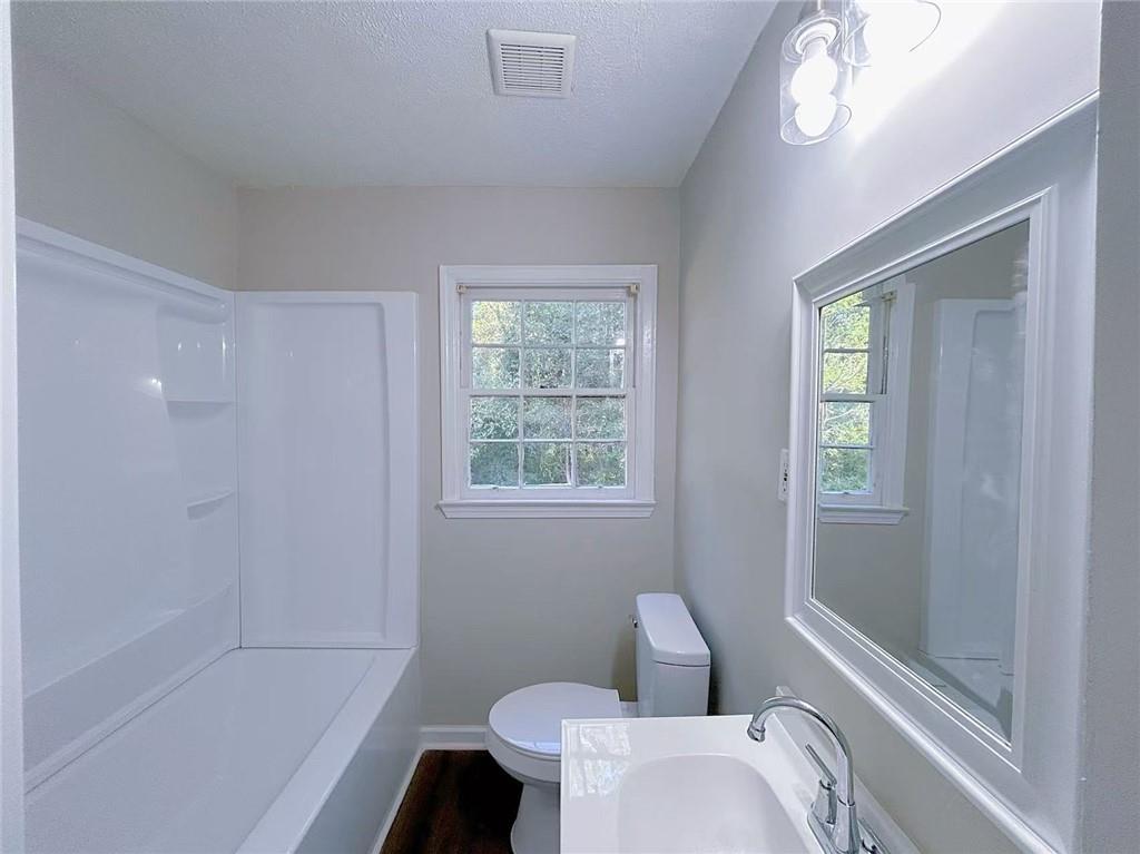 2126 Ivydale Street Atlanta, GA 30344 - Photo 9 of 11 a bathroom with a toilet and a shower