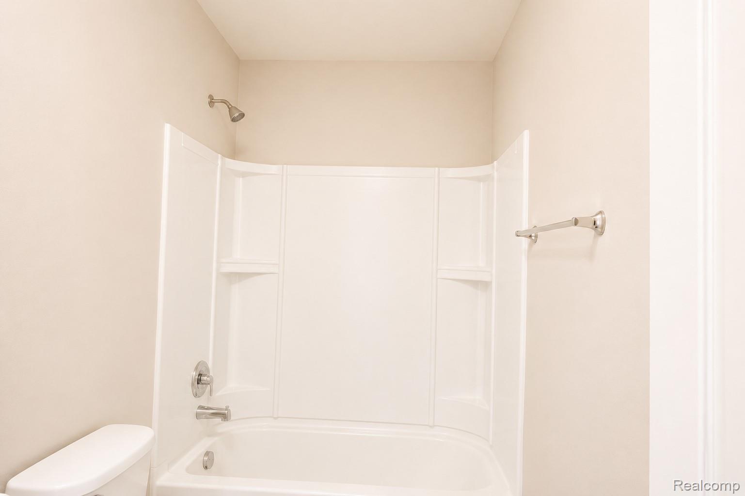 2940 Glenbar Circle Rochester, MI 48307 - Photo 13 of 15 White tub and shower combination with chrome fixtures and integrated shelving