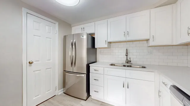 a kitchen with appliances a sink and cabinets