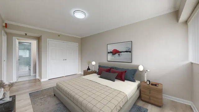 a bedroom with a bed and a painting on the wall