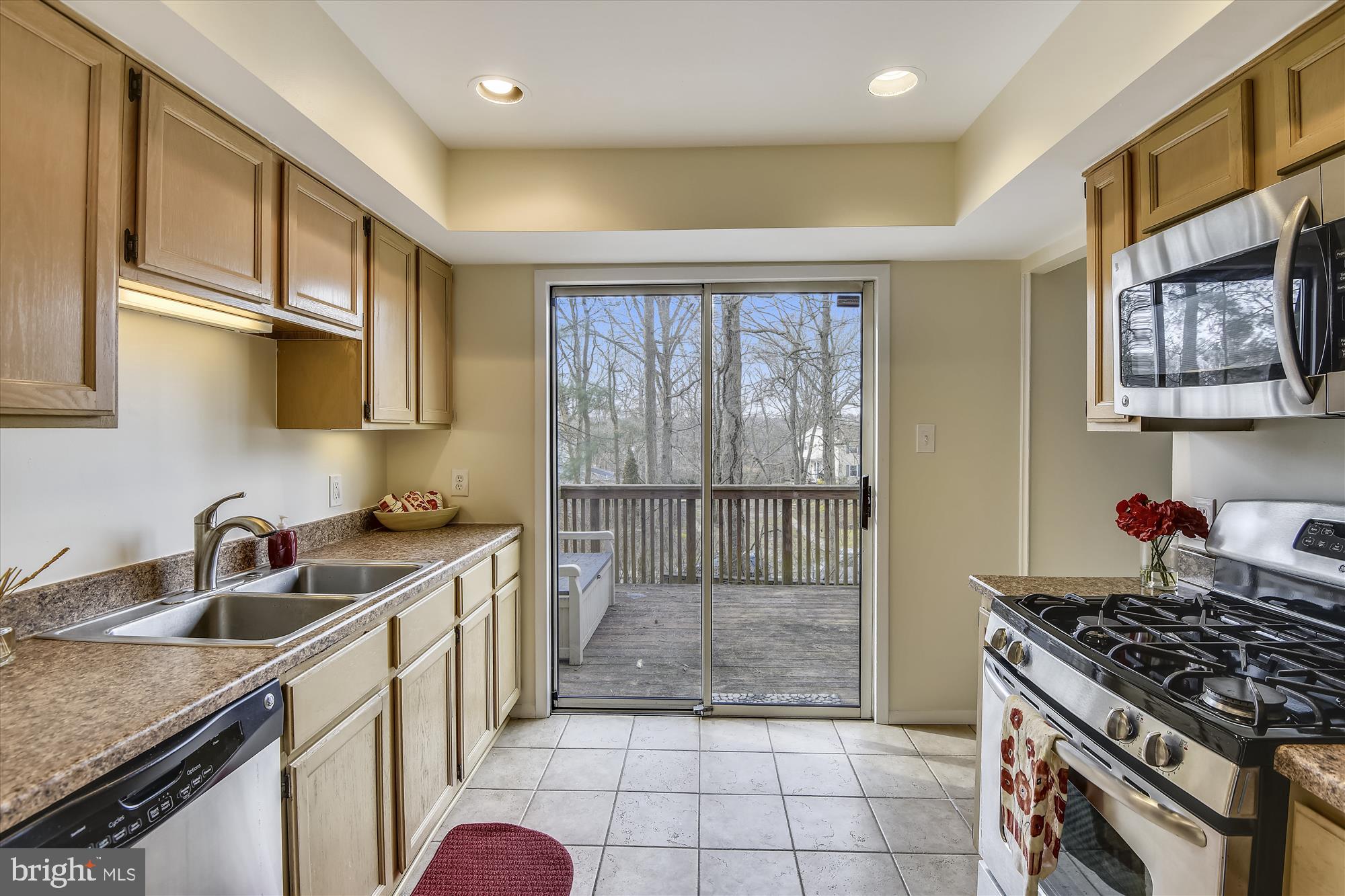 1752 Whitfield Court Crofton, MD 21114 - Photo 7 of 30 a kitchen that has a sink a stove and a wooden cabinets