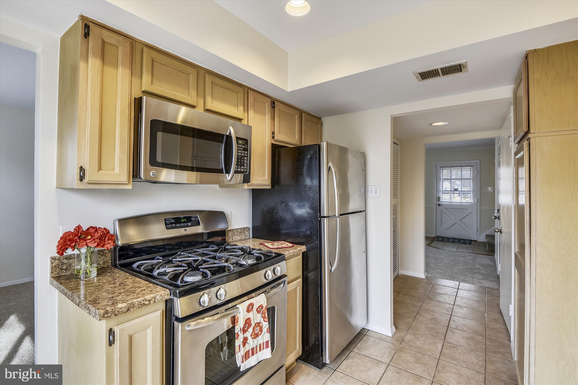 1752 Whitfield Court Crofton, MD 21114 - Photo 8 of 30 a kitchen with stainless steel appliances granite countertop a stove refrigerator and microwave