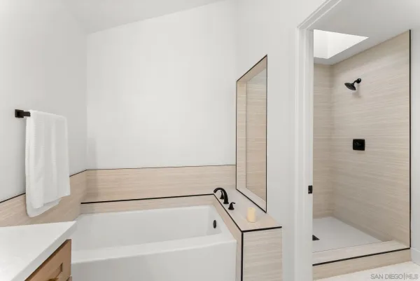 a bathroom with a tub and a shower