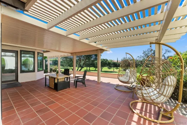 a view of a patio with a dining table and chairs