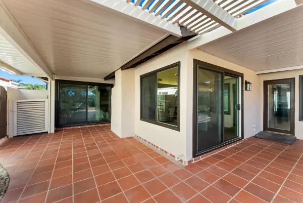 a view of a brick house with a glass door