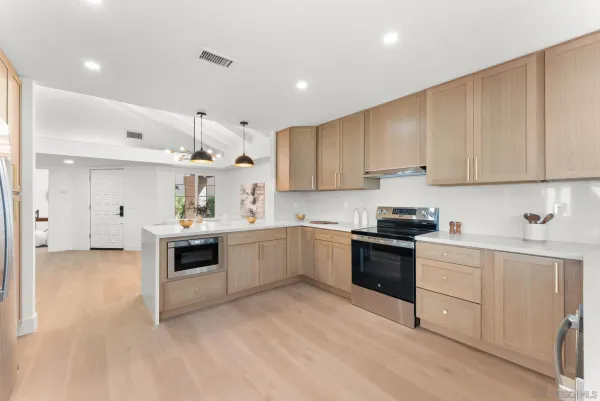 a kitchen with granite countertop white cabinets and white appliances