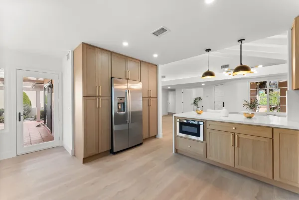 a kitchen with stainless steel appliances a sink stove and refrigerator