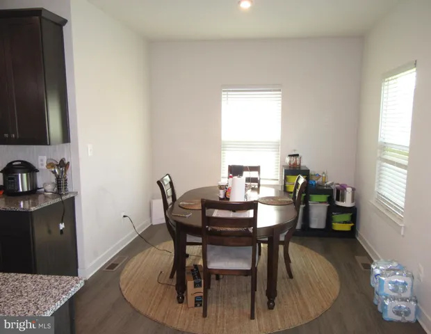 a view of a dining room with furniture and window