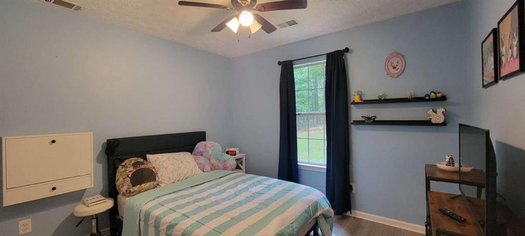 2140 Summerset Drive Monroe, GA 30656 - Photo 23 of 43 a bedroom with a bed and a chandelier