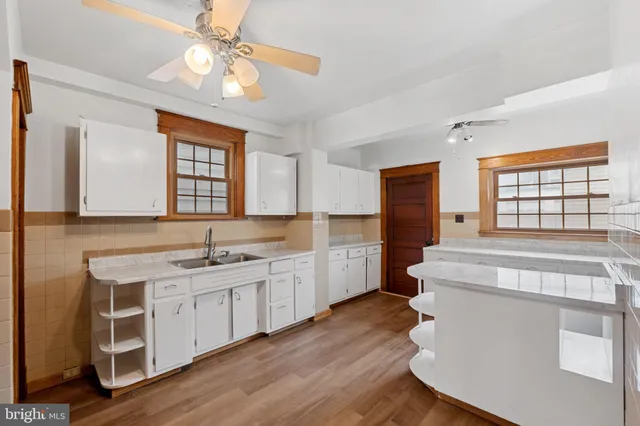 a kitchen with a sink dishwasher a refrigerator and cabinets