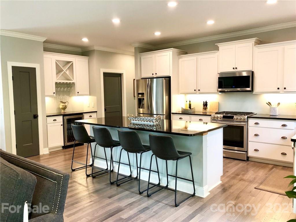 592 Cabin Creek Road Biscoe, NC 27209 - Photo 5 of 20 a kitchen with stainless steel appliances kitchen island granite countertop a sink and cabinets