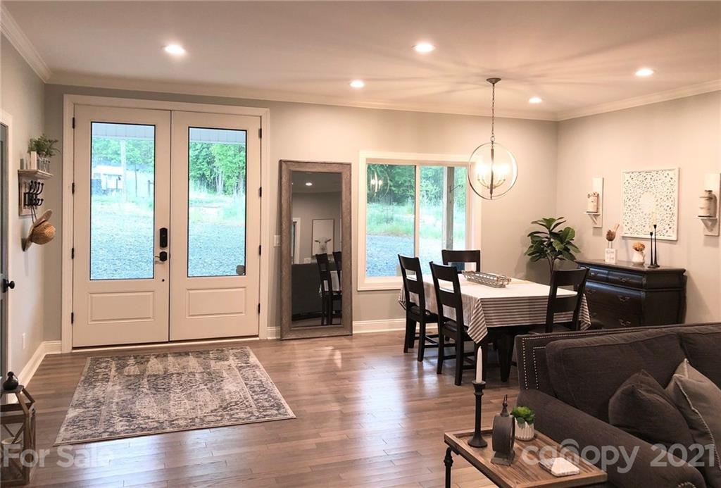 592 Cabin Creek Road Biscoe, NC 27209 - Photo 7 of 20 a view of a a dining room with furniture window and wooden floor