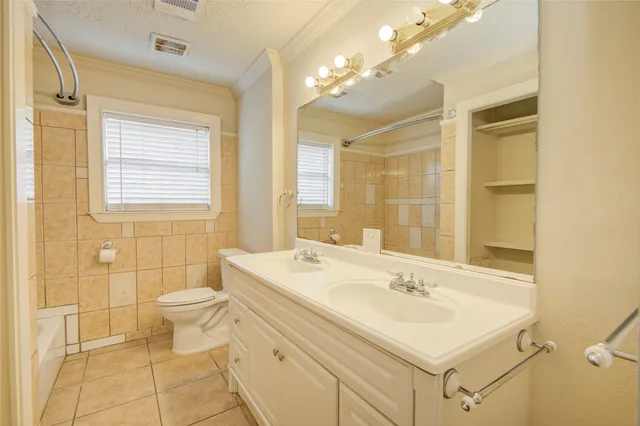 a bathroom with a sink a toilet a mirror and shower