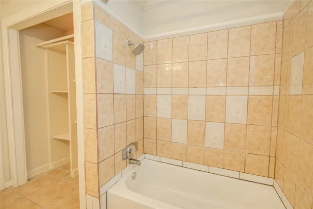 a bathroom with a bathtub and shower