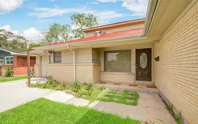 a front view of a house with garden