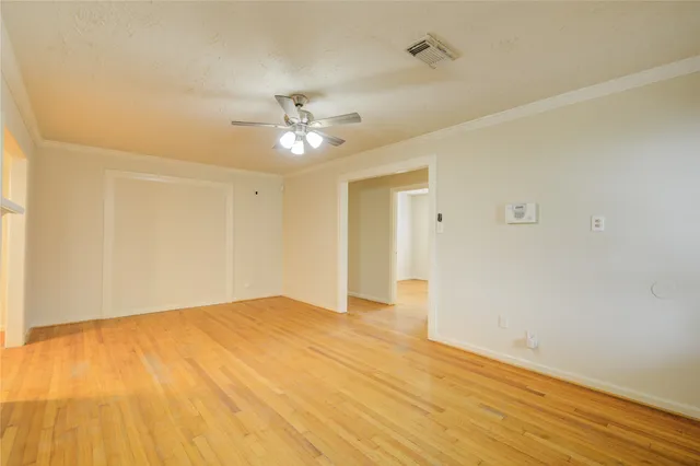 a view of an empty room and wooden floor