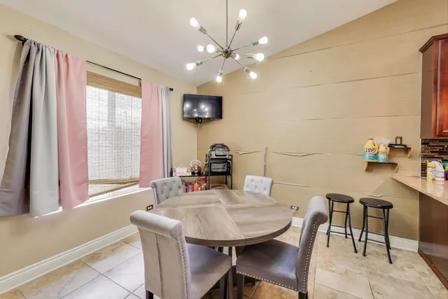 a view of a dining room with furniture and a large window