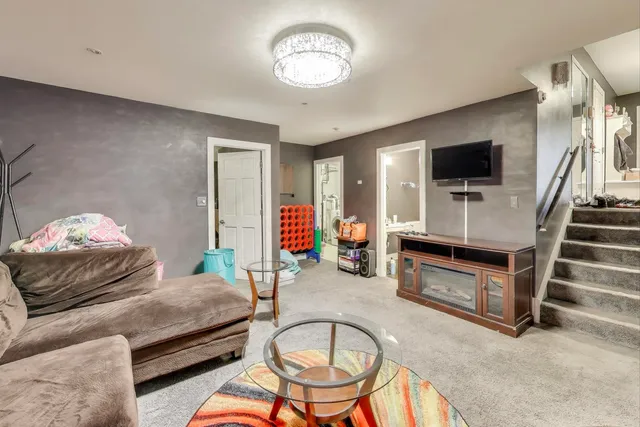 a bedroom with furniture and a flat screen tv