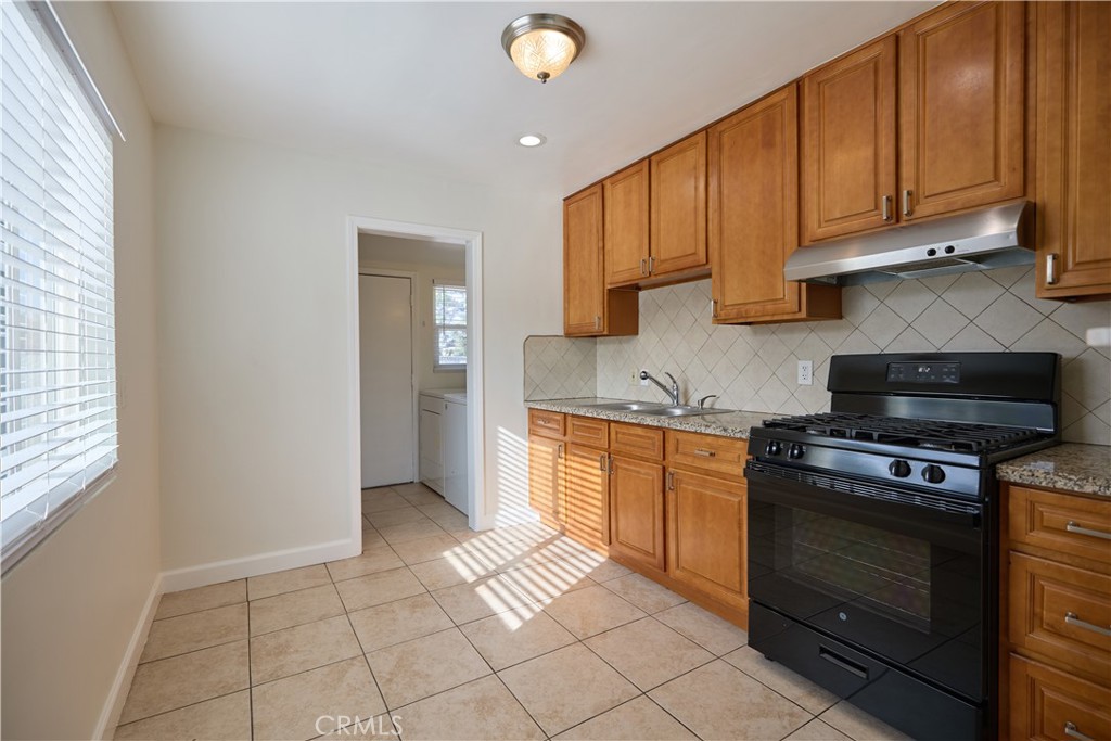 3644 Russell Street Riverside, CA 92501 - Photo 6 of 20 Kitchen with space for small dining area. Laundry, refrigerator, and pantry off of the kitchen.