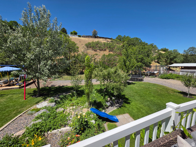 387 North Loafer Canyon Road Payson, UT 84651 - Photo 70 of 94 Expansive outdoor space featuring a manicured lawn, established trees, and natural landscaping with rock elements
