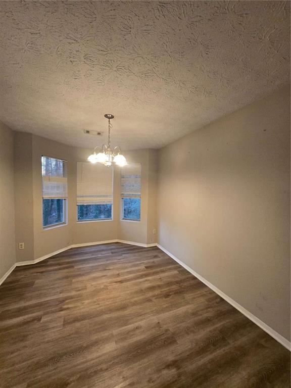 1717 Rondon Court Atlanta, GA 30316 - Photo 4 of 12 a view of an empty room with window and wooden floor